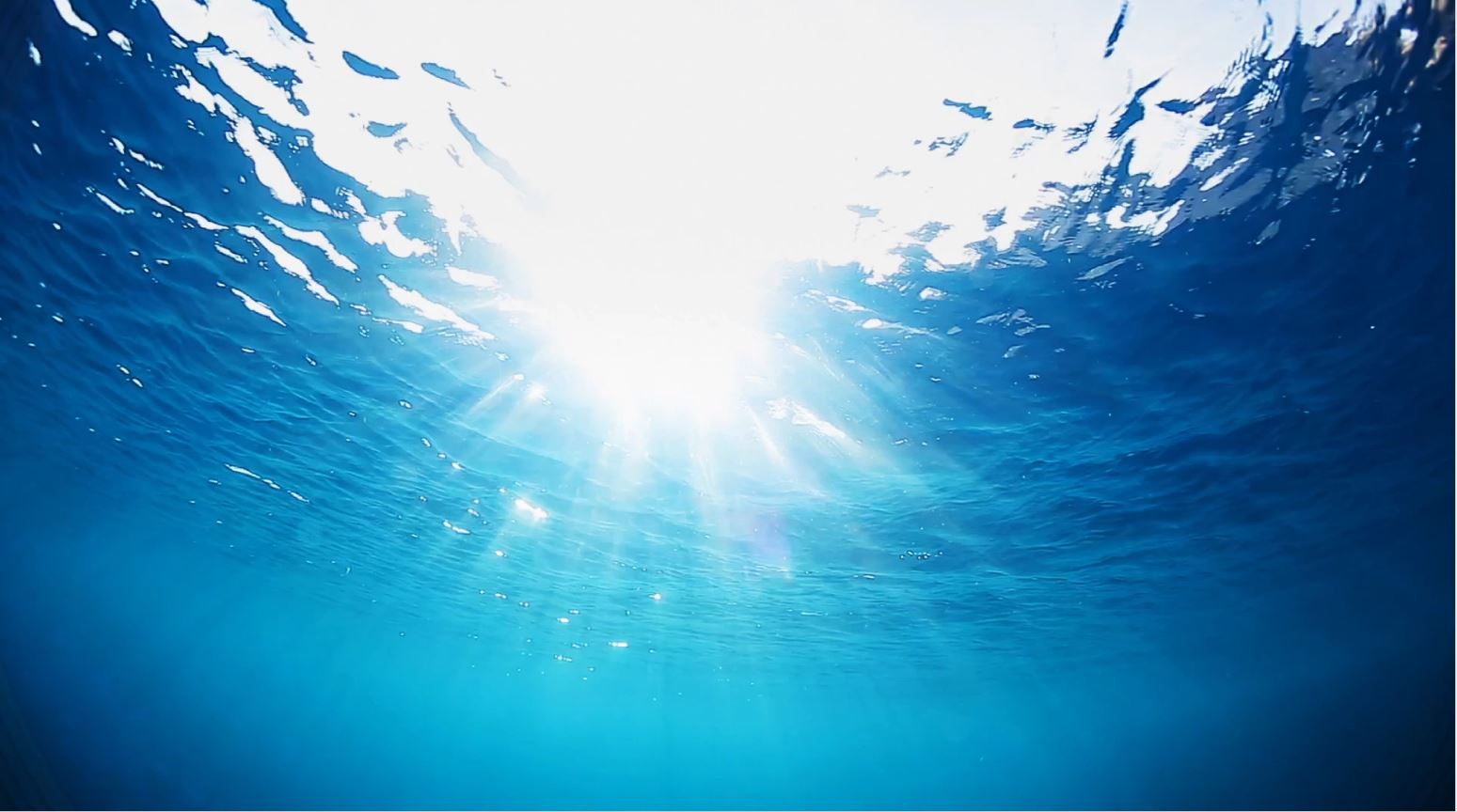 dazzling light shining through the ocean